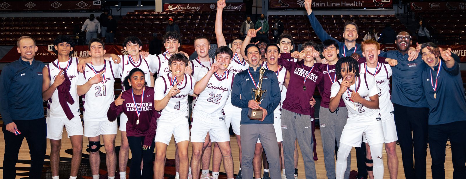 Coach Forcine and the Conestoga team celebrating with the championship trophy